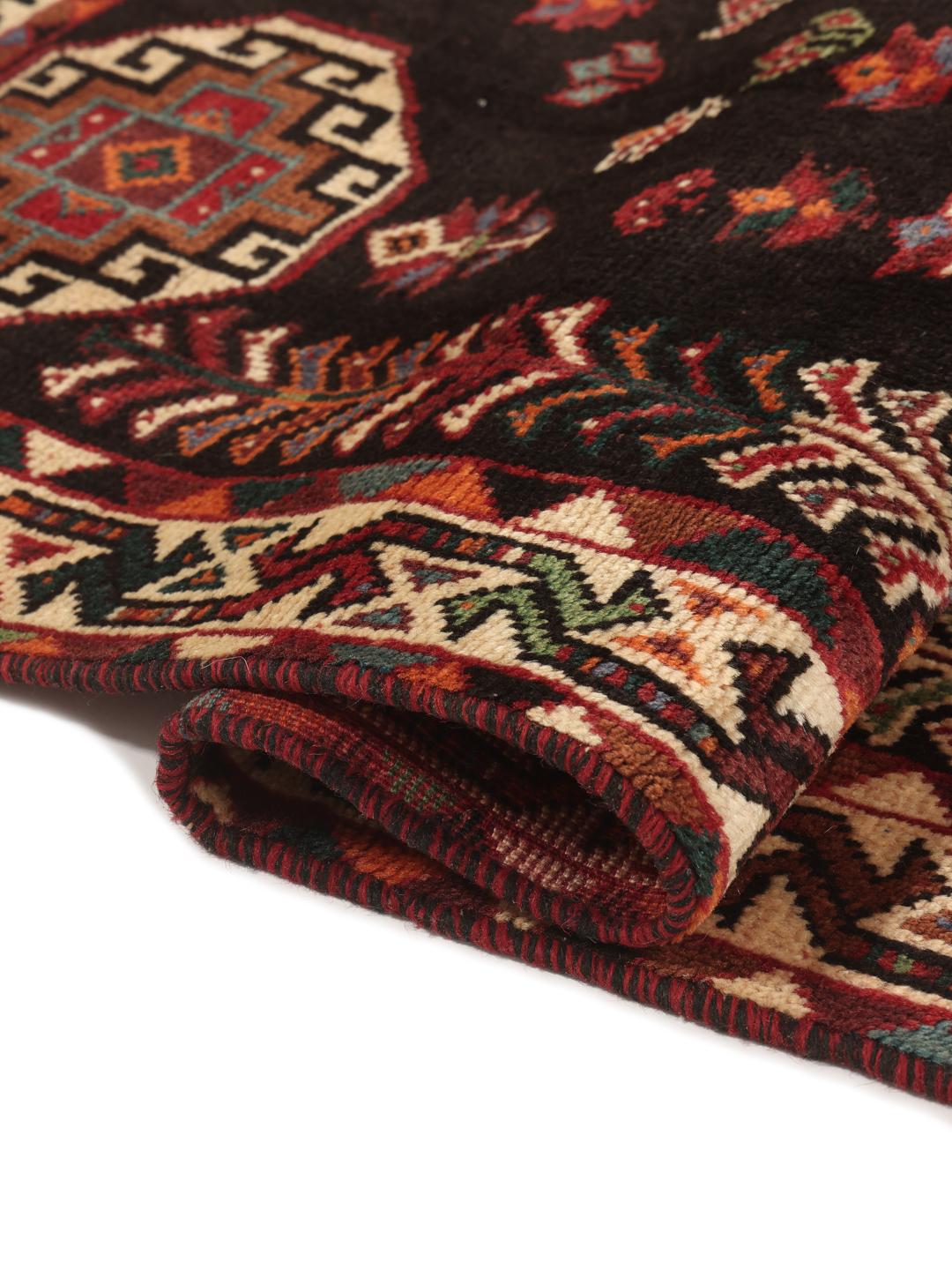 Hand-woven Shiraz rug from the Middle East featuring a vibrant red field and tribal motifs