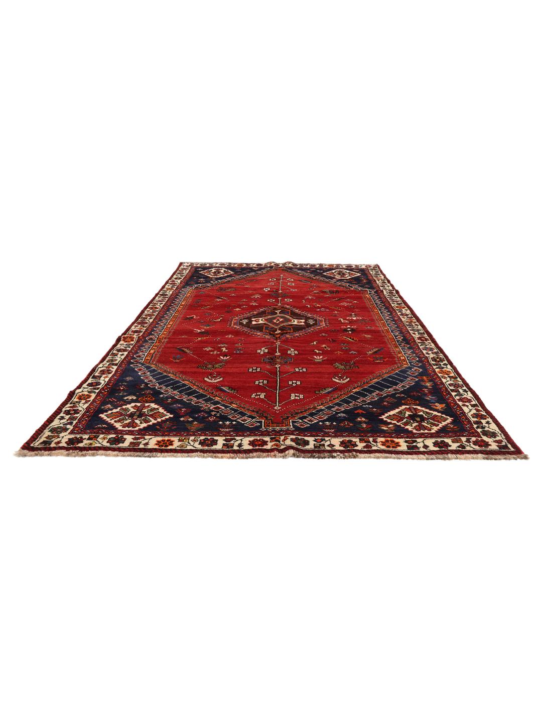 Hand-knotted Qashqai rug with a red field and geometric tribal patterns