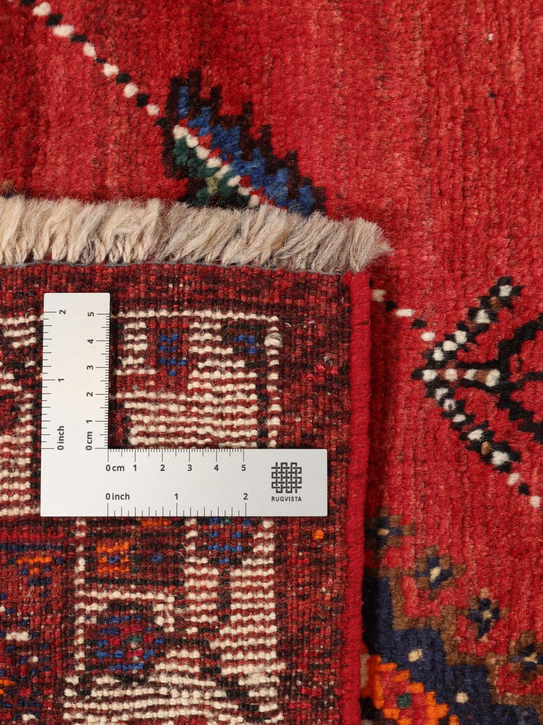 Hand-knotted Qashqai rug with a red field and geometric tribal patterns