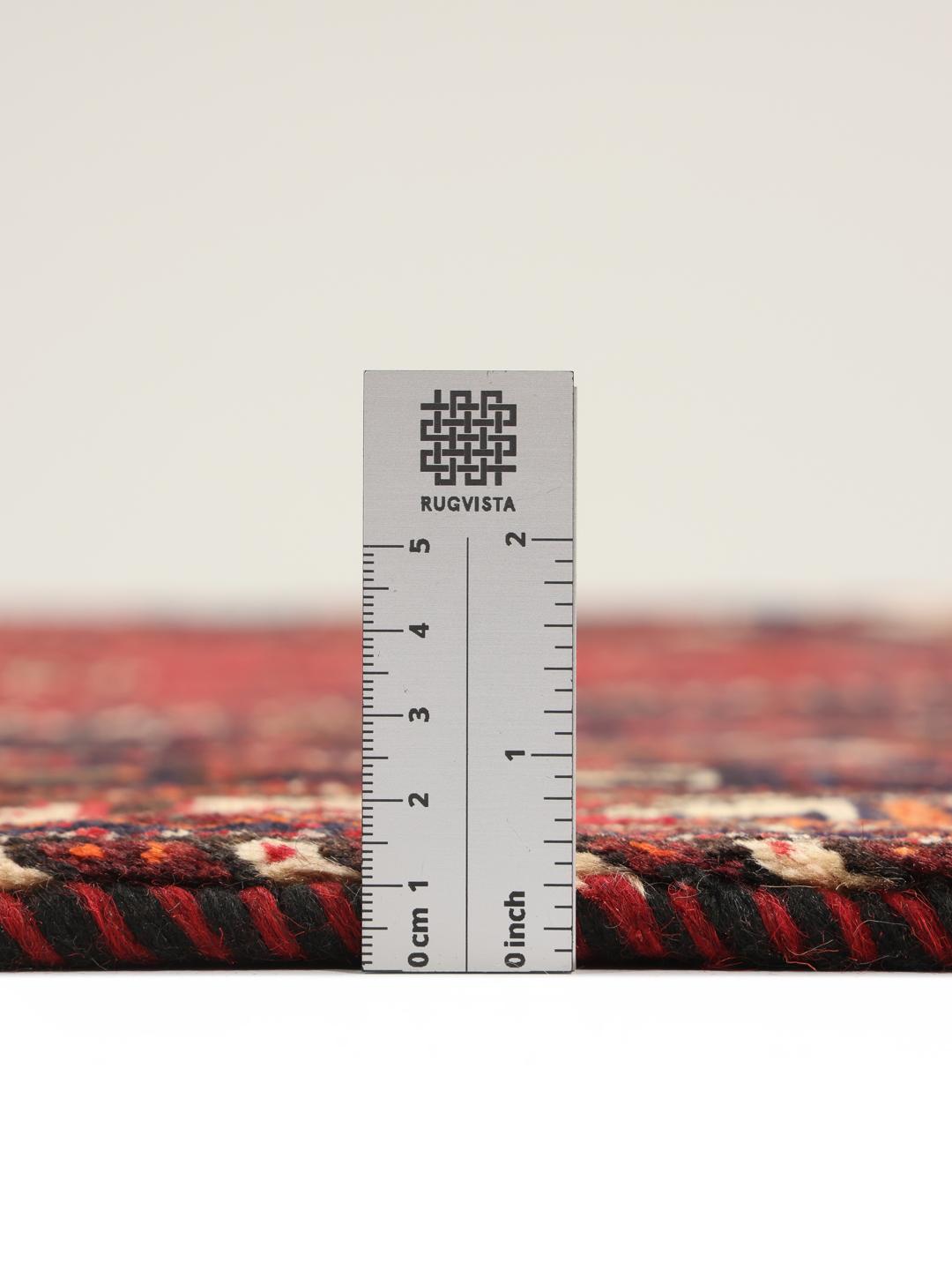 Hand-knotted Middle Eastern tribal rug with red and black geometric patterns