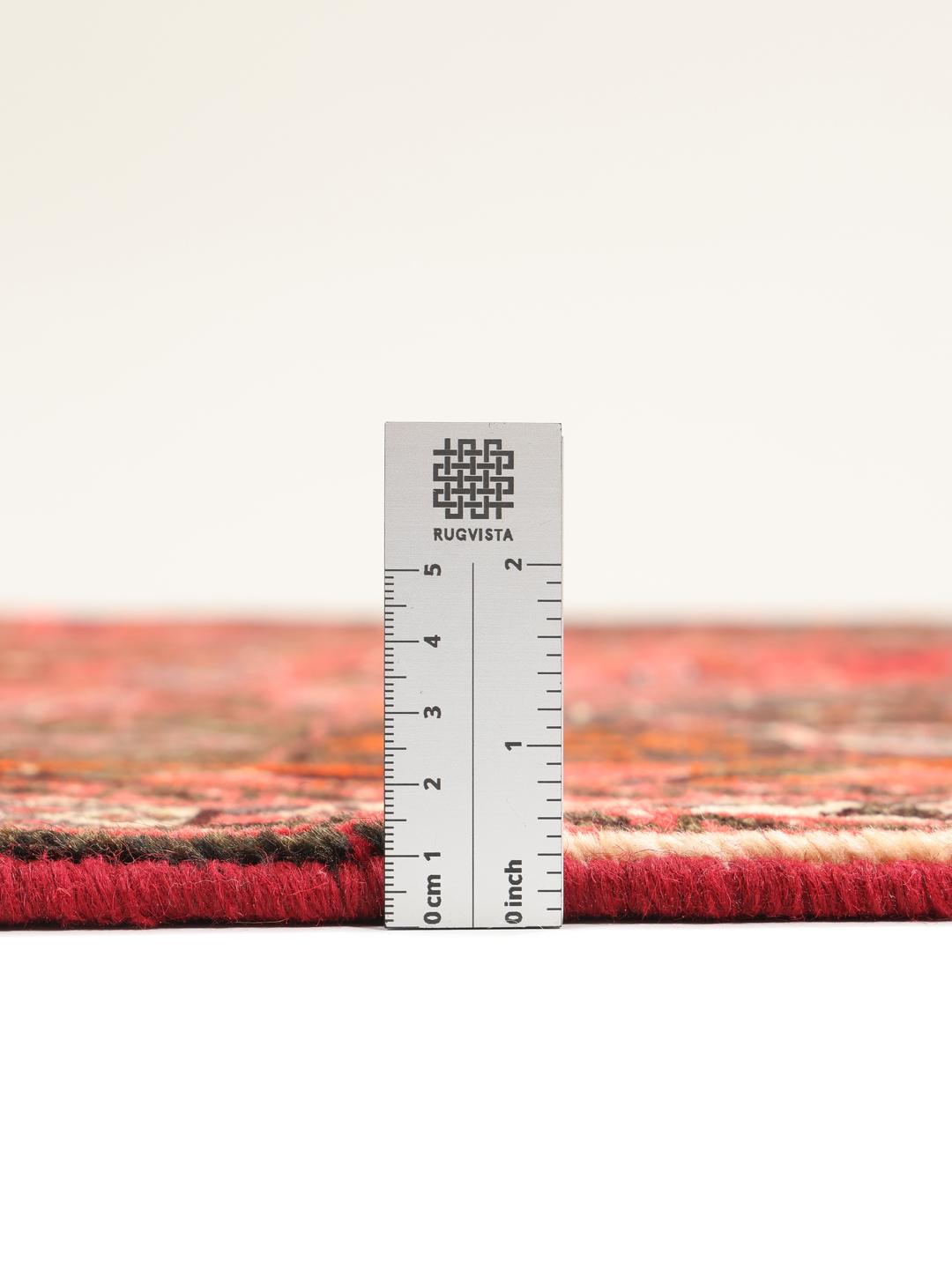 A beautiful hand-knotted Qashqai rug from the Middle East with a red field and traditional patterns.