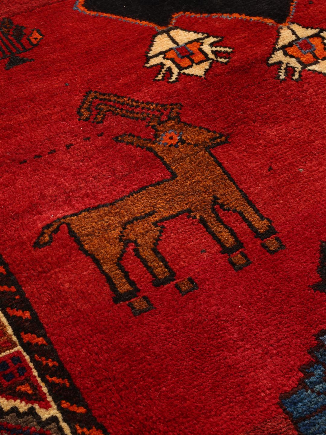 Hand-knotted Middle Eastern Ghashghai rug in red with tribal pictorial motifs