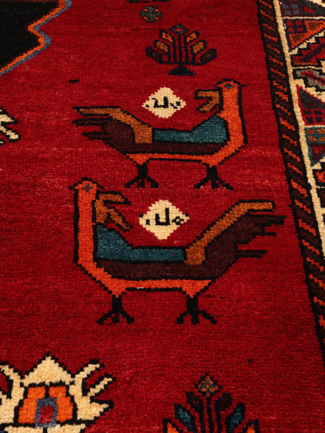 Hand-knotted Middle Eastern Ghashghai rug in red with tribal pictorial motifs