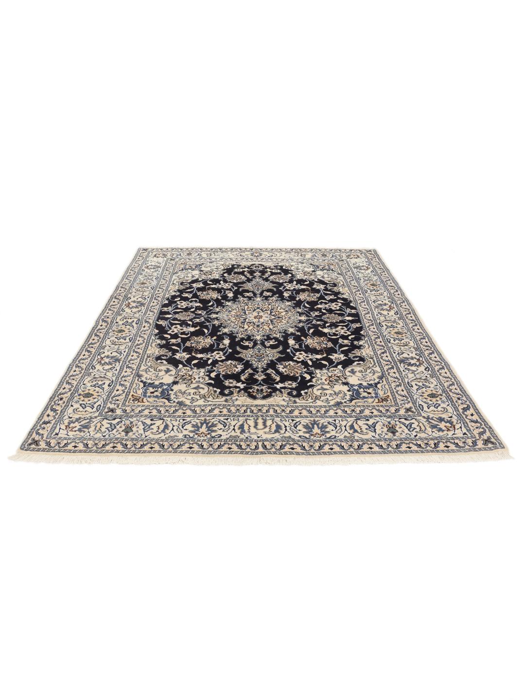 A hand-knotted Nain rug from the Middle East featuring a blue and beige floral design.