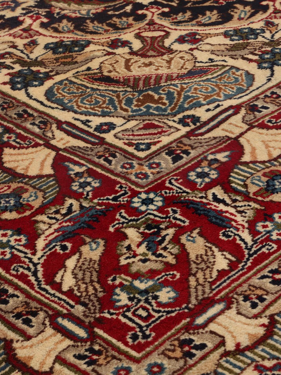 Et detaljeret, håndknyttet Kashmar-tæppe fra Mellemøsten med et indviklet mørkerødt og mørkeblåt design.