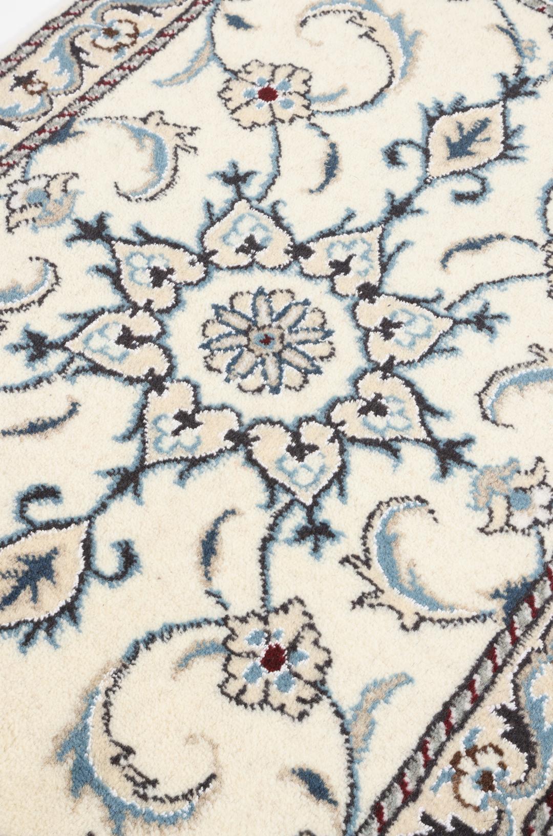 Hand-knotted Nain rug with floral patterns in beige and blue from the Middle East
