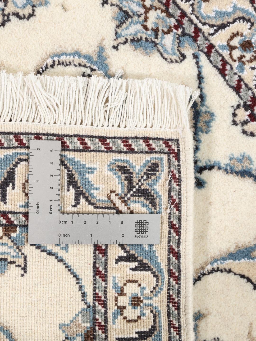 Hand-knotted Nain rug with floral patterns in beige and blue from the Middle East