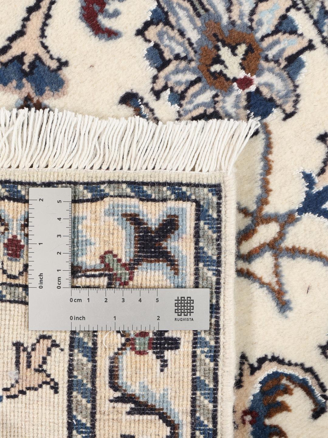 Hand-knotted Nain rug from the Middle East in beige, blue, and red tones.