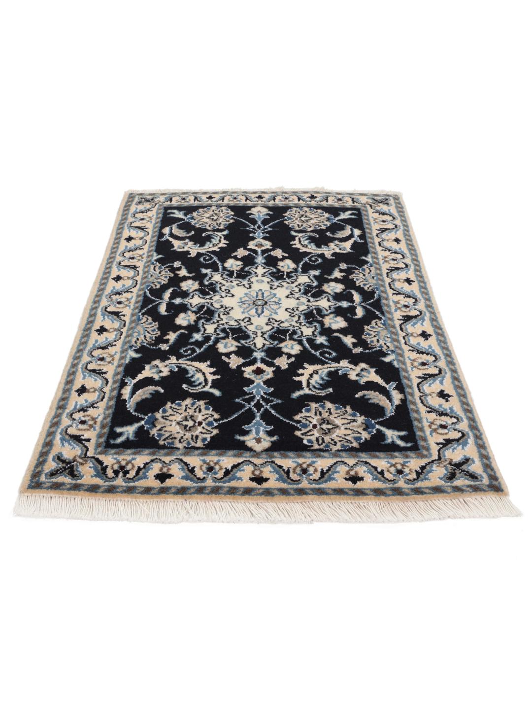 A hand-knotted Nain rug from the Middle East featuring a black field with floral patterns