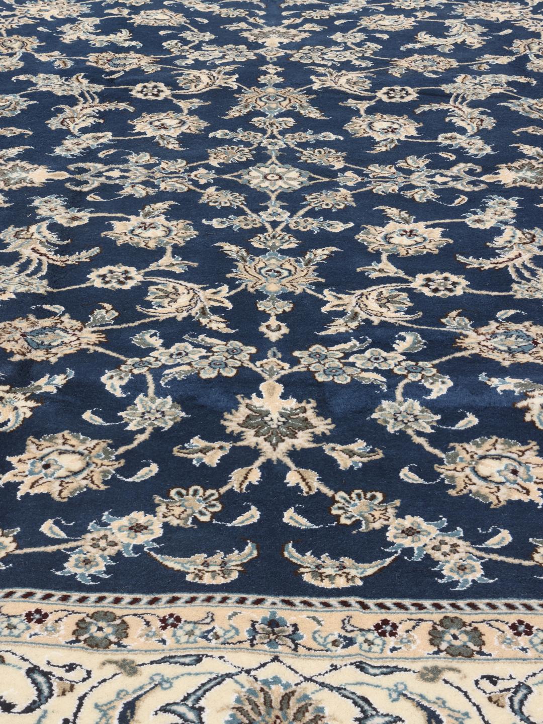 Hand-knotted Nain rug from the Middle East with a deep blue floral pattern