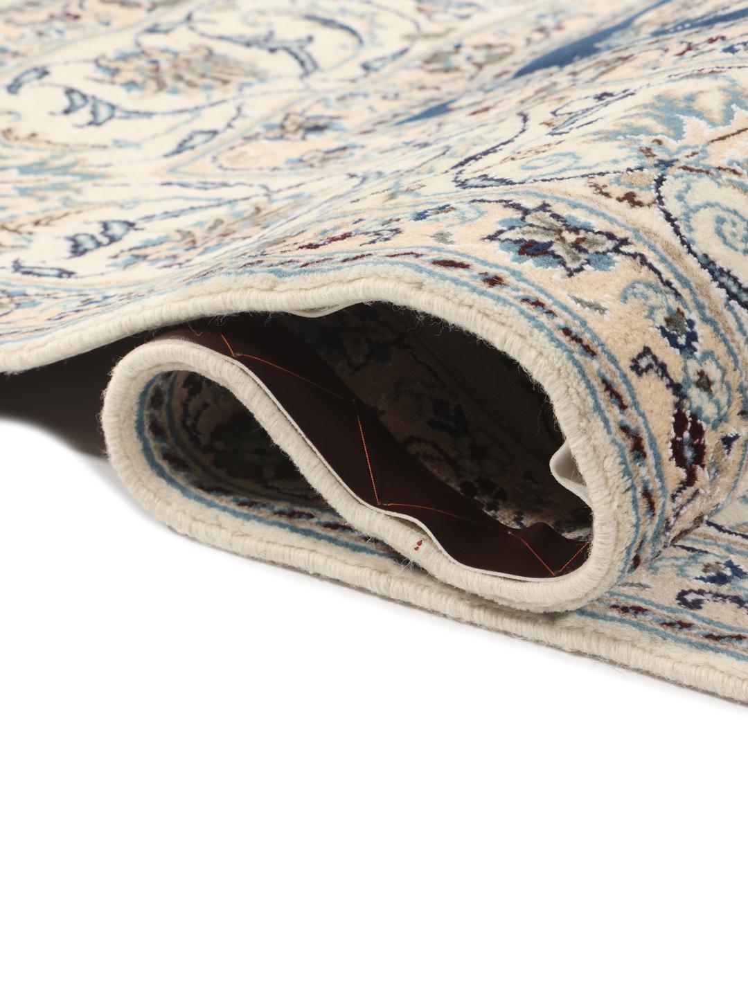 Hand-knotted Nain rug from the Middle East with a deep blue floral pattern