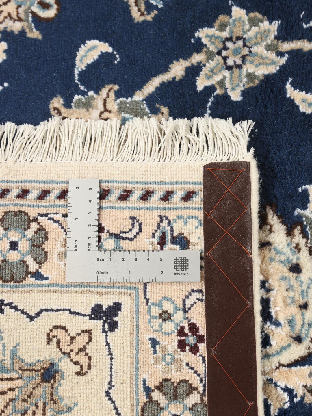 Hand-knotted Nain rug from the Middle East with a deep blue floral pattern