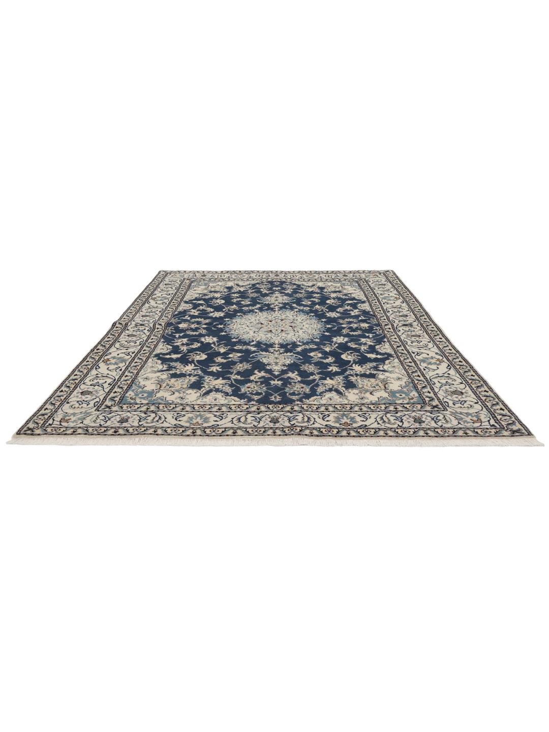 Hand-knotted Nain rug from the Middle East featuring a blue field with floral patterns.