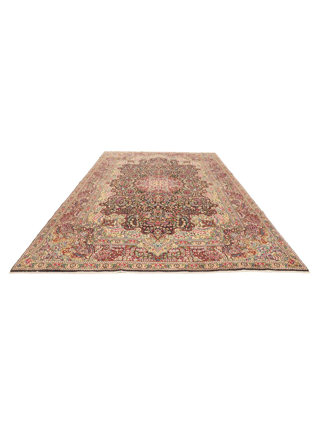 A large, rectangular Kerman rug from the Middle East featuring a complex red and dark red floral medallion pattern.