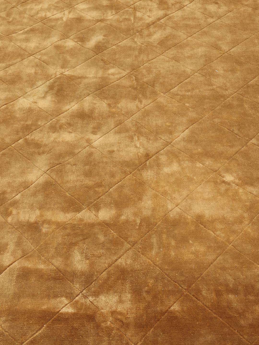 A warm brown rug with a diamond pattern