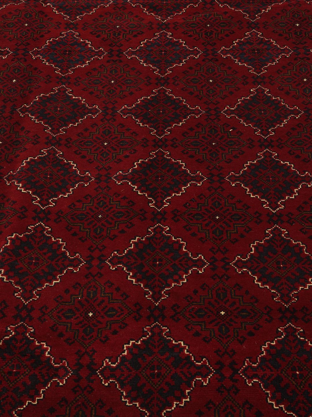 Hand-knotted Kunduz rug from the Middle East in deep red
