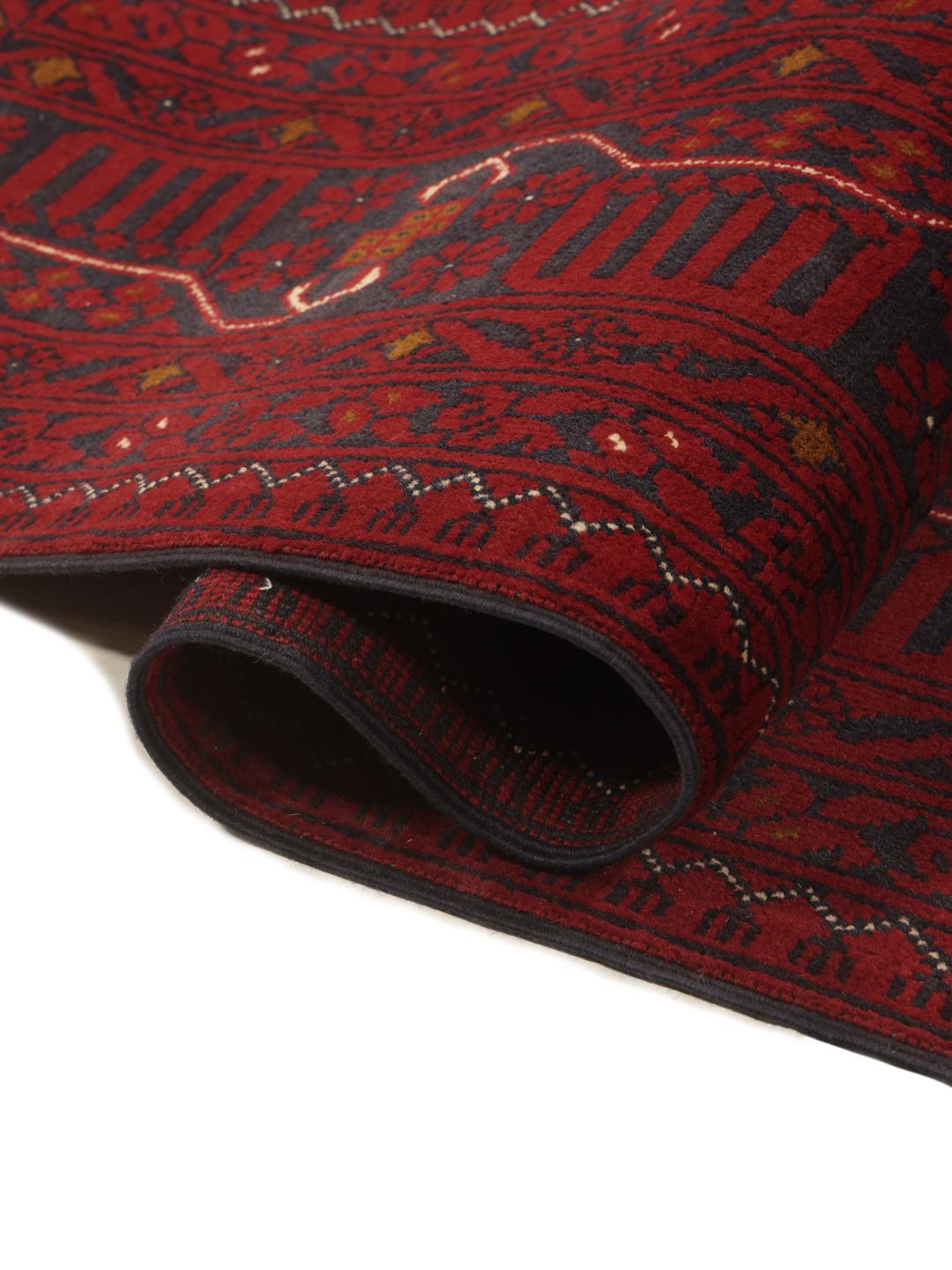 Hand-knotted Kunduz rug from the Middle East in deep red