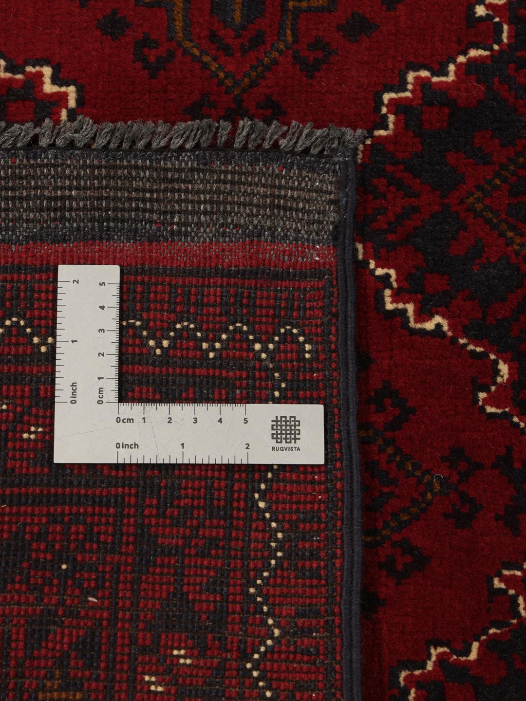 Hand-knotted Kunduz rug from the Middle East in deep red