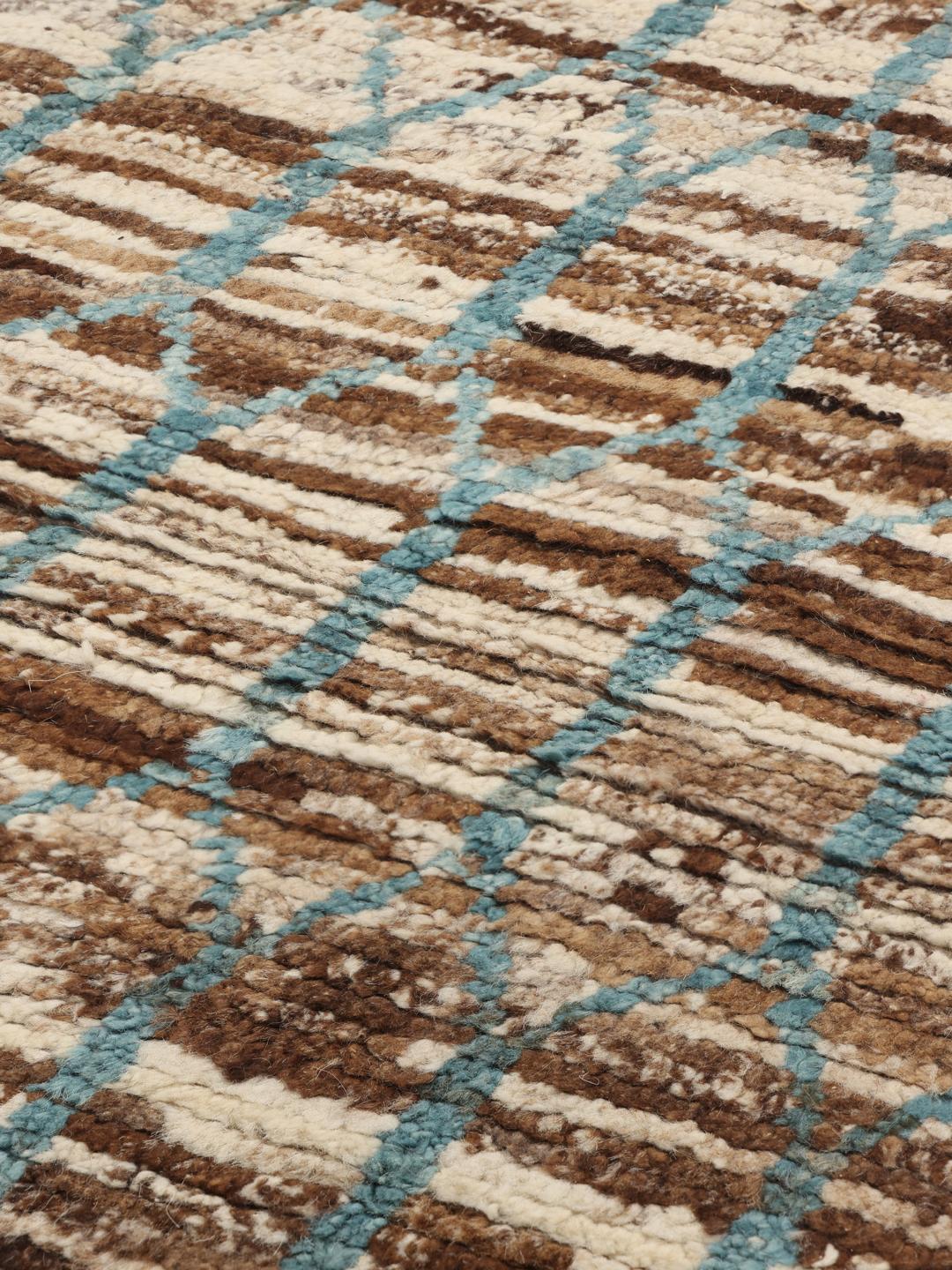 Handgeknoopt wollen tapijt uit Afghanistan met een geometrisch patroon in bruin en blauwgroen