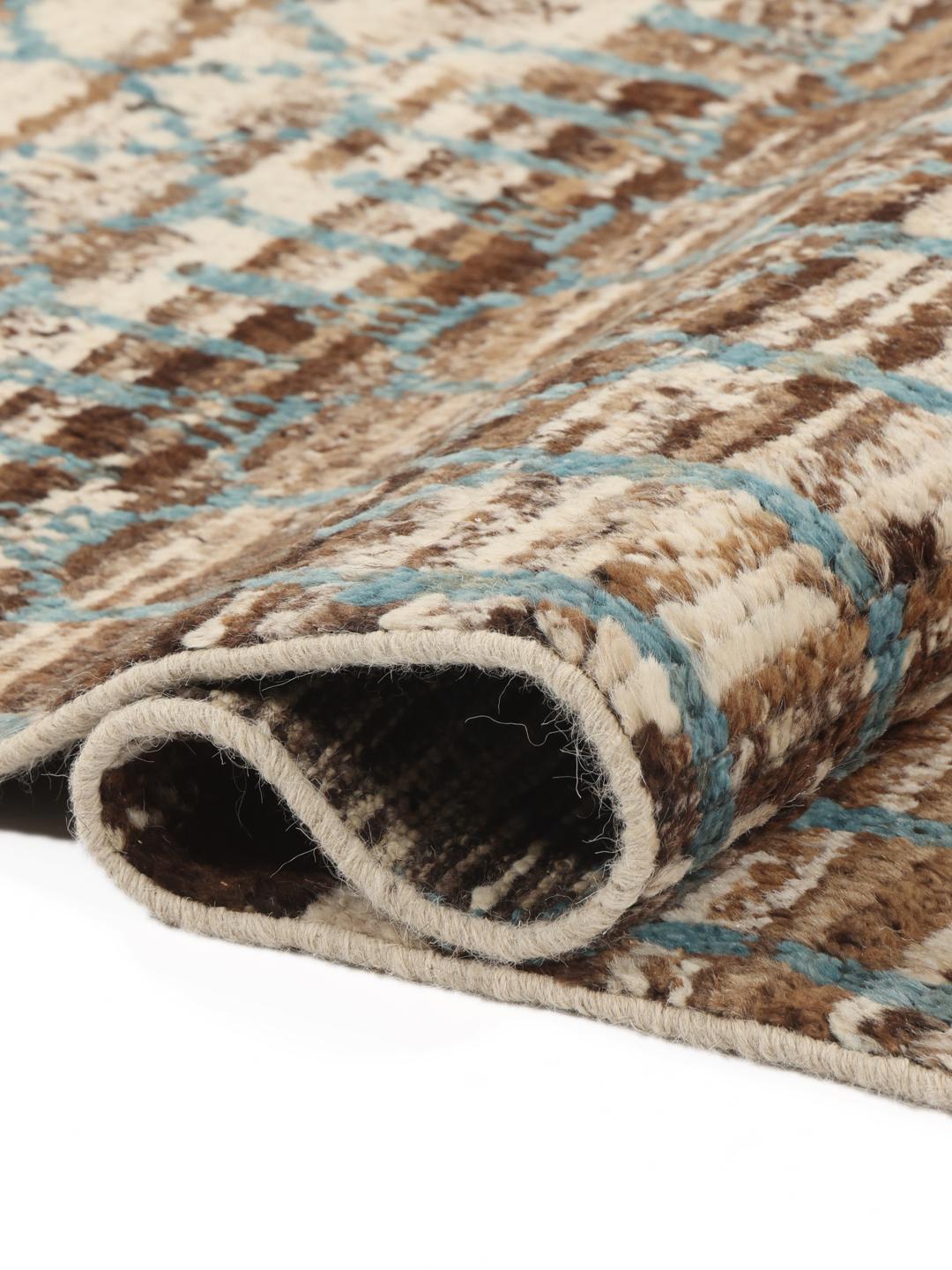 Handgeknoopt wollen tapijt uit Afghanistan met een geometrisch patroon in bruin en blauwgroen