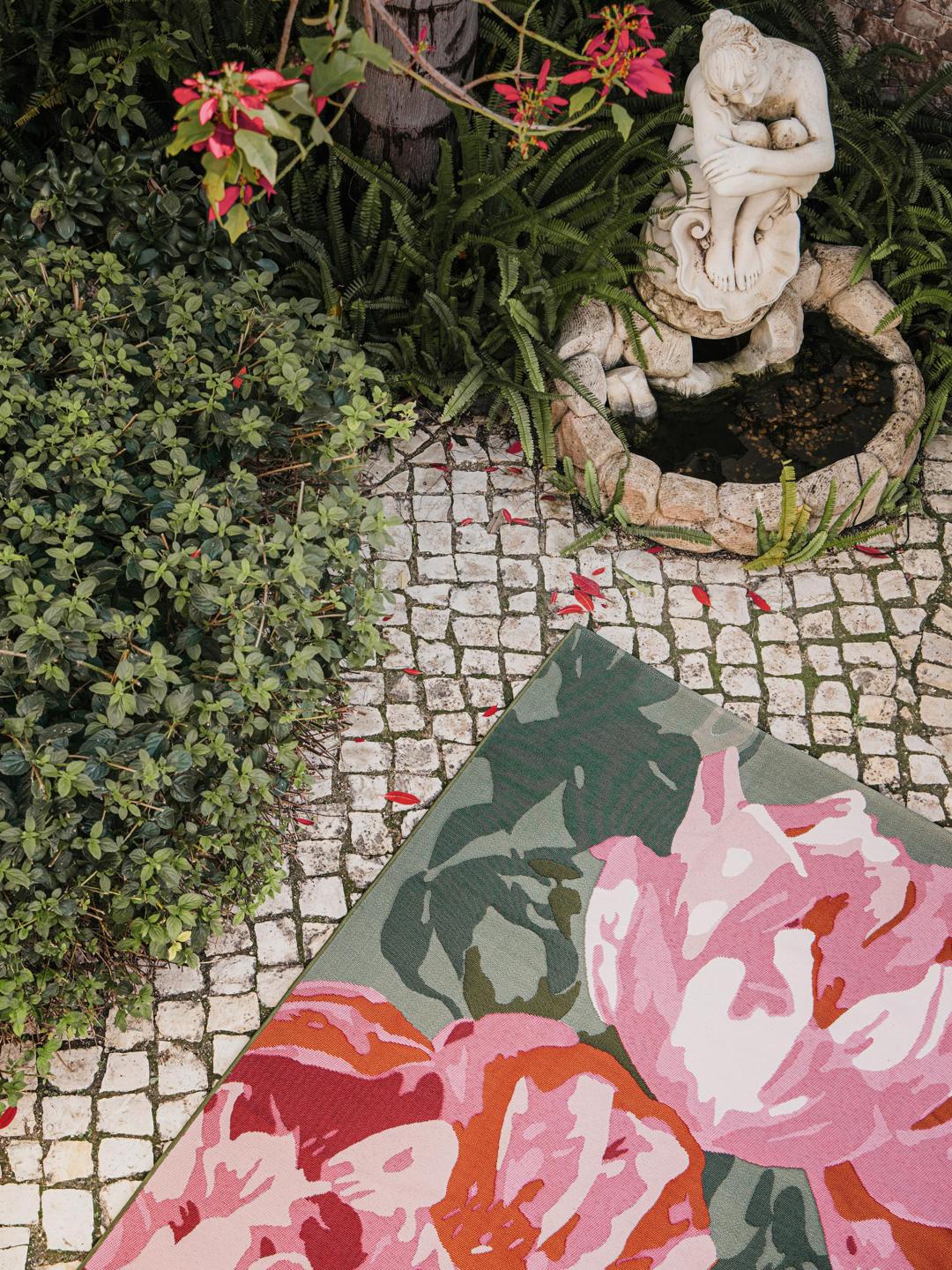 Pink and green rug with large floral pattern