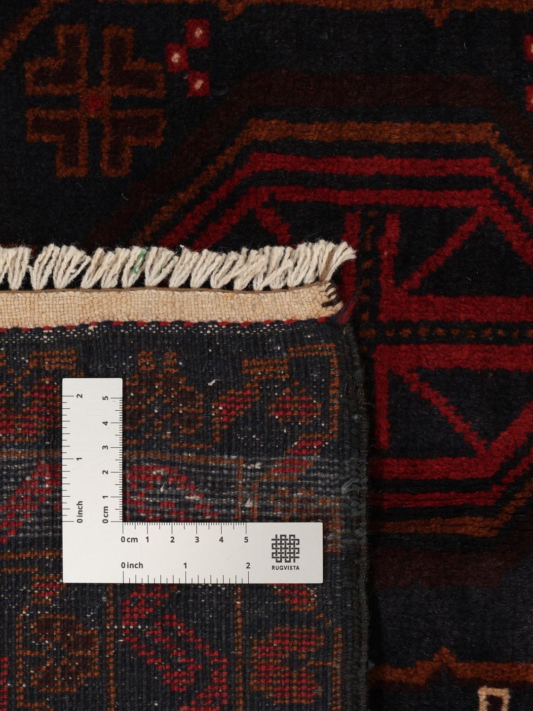 Håndknyttet afghansk løber i rød og mørkeblå med geometriske medaljoner.