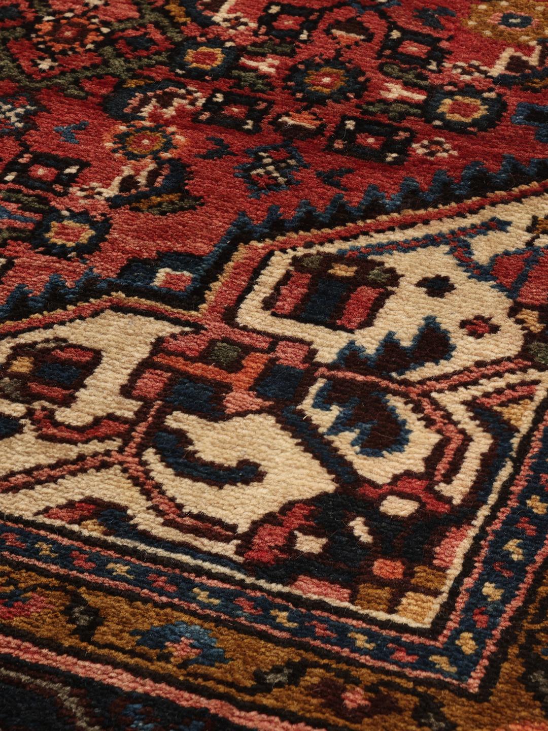 Hand-knotted Hosseinabad Wool rug from the Middle East in deep red