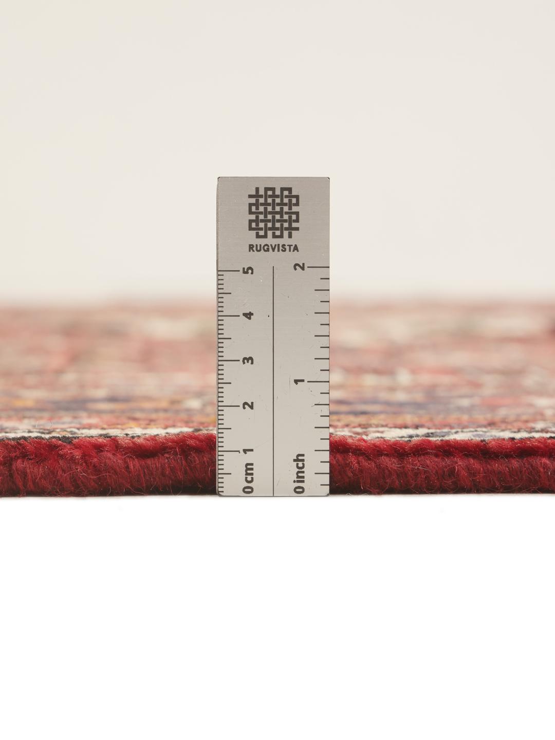 Hand-knotted Hosseinabad rug from the Middle East in deep red and dark blue tones.