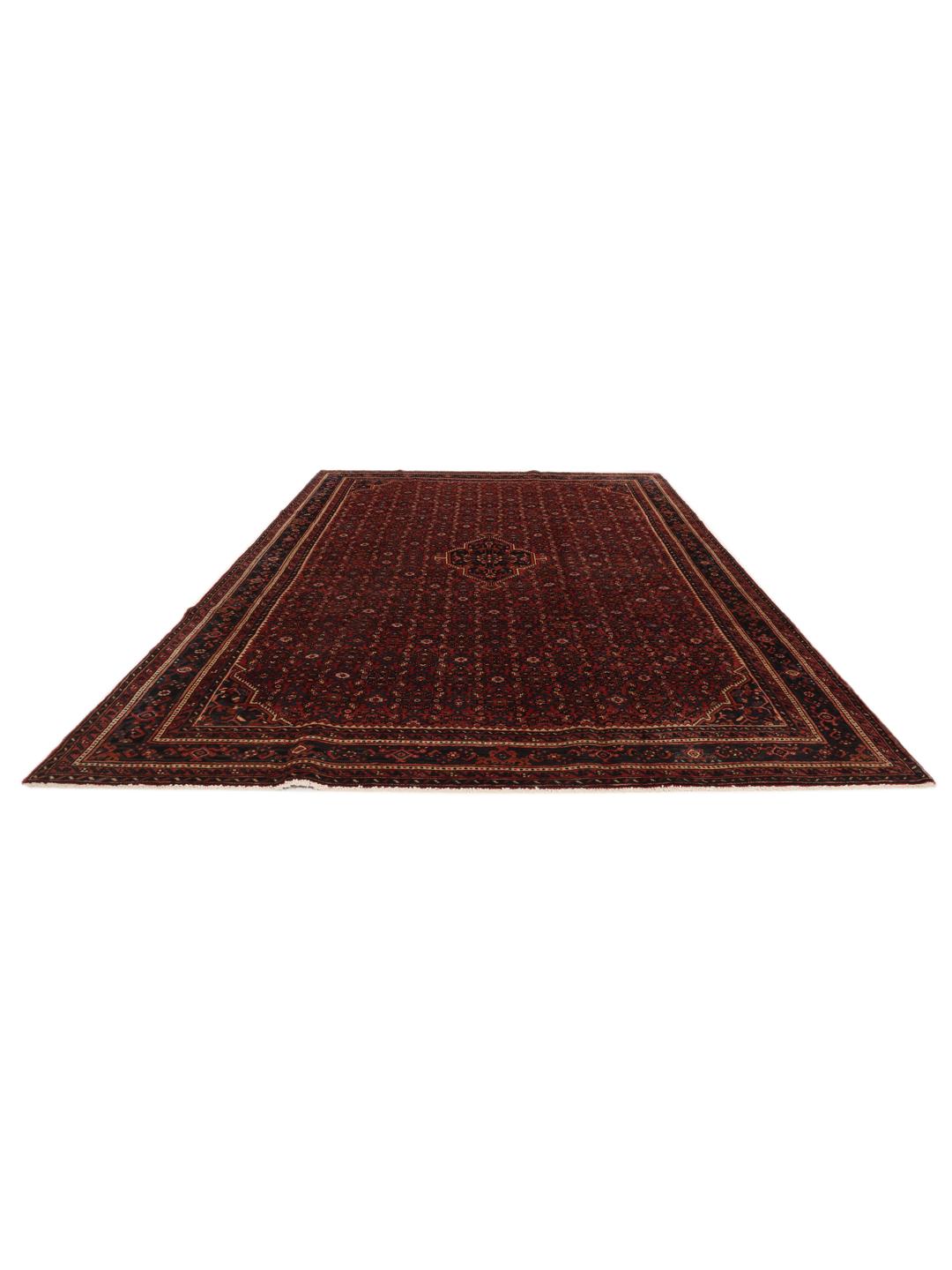 A hand-knotted Hosseinabad rug featuring a traditional dark-red field and detailed patterns.