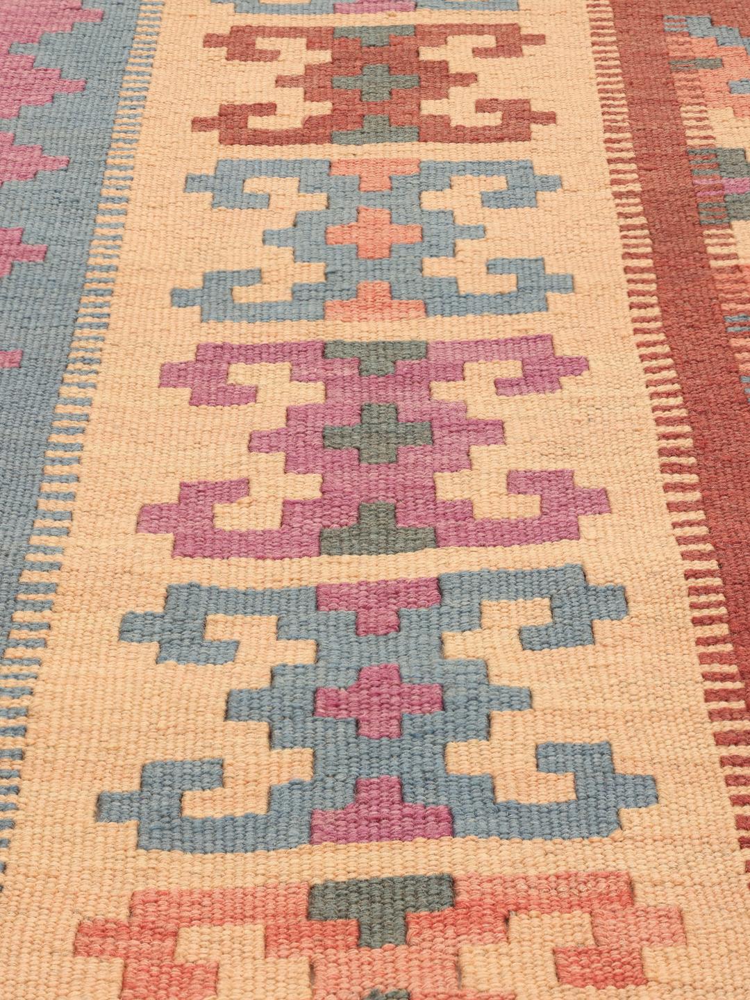 A hand-woven multicolor Kelim Ghashghai rug with geometric diamond patterns.