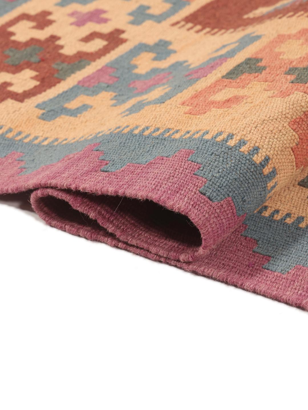 A hand-woven multicolor Kelim Ghashghai rug with geometric diamond patterns.