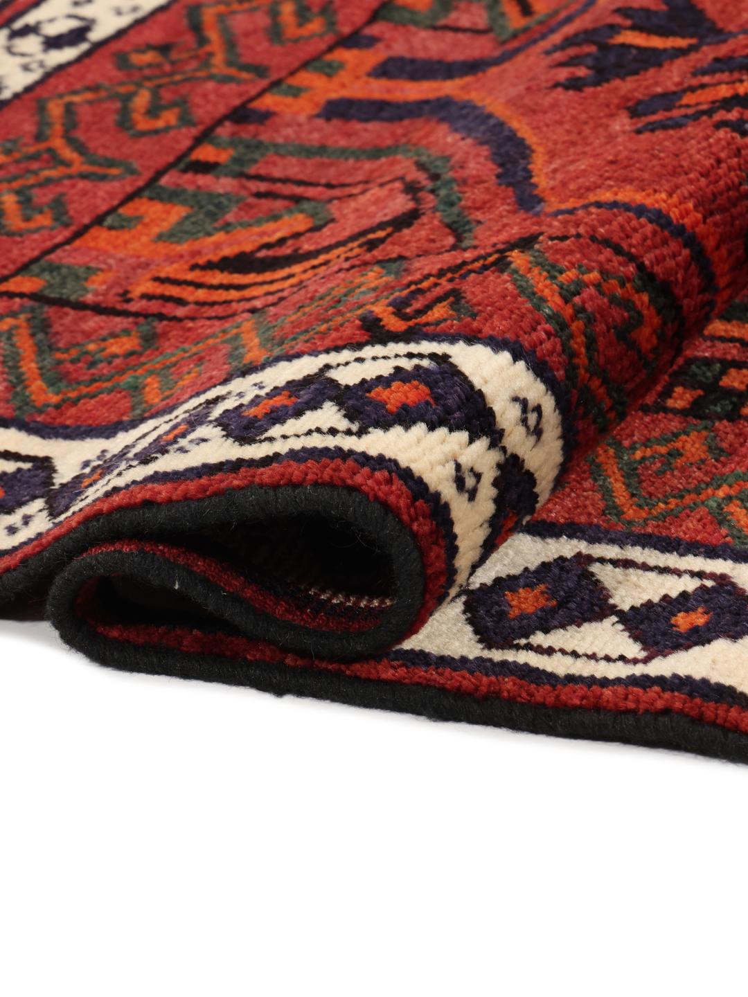 Hand-knotted Lori rug from the Middle East featuring a deep red base with geometric motifs
