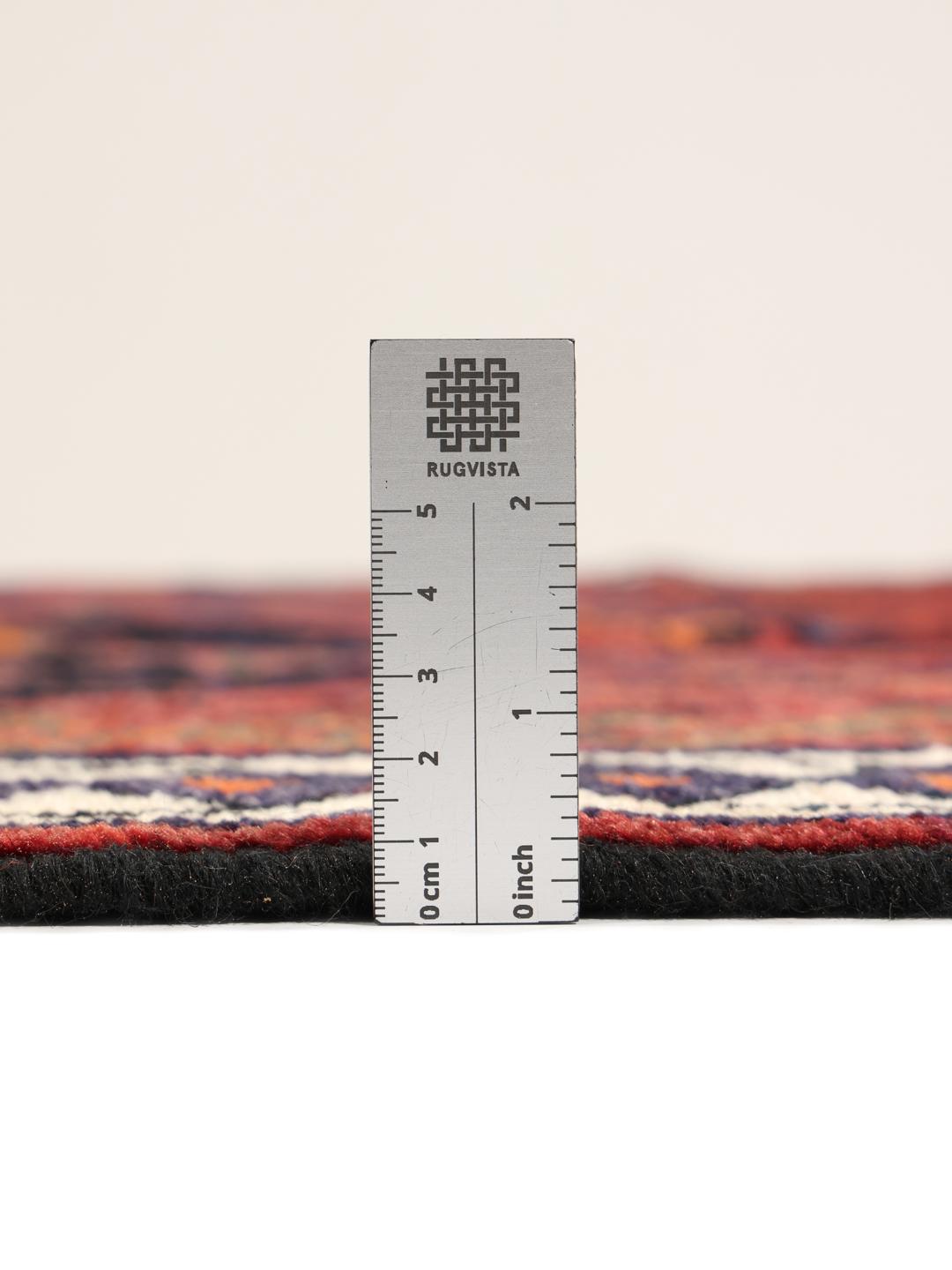 Hand-knotted Lori rug from the Middle East featuring a deep red base with geometric motifs