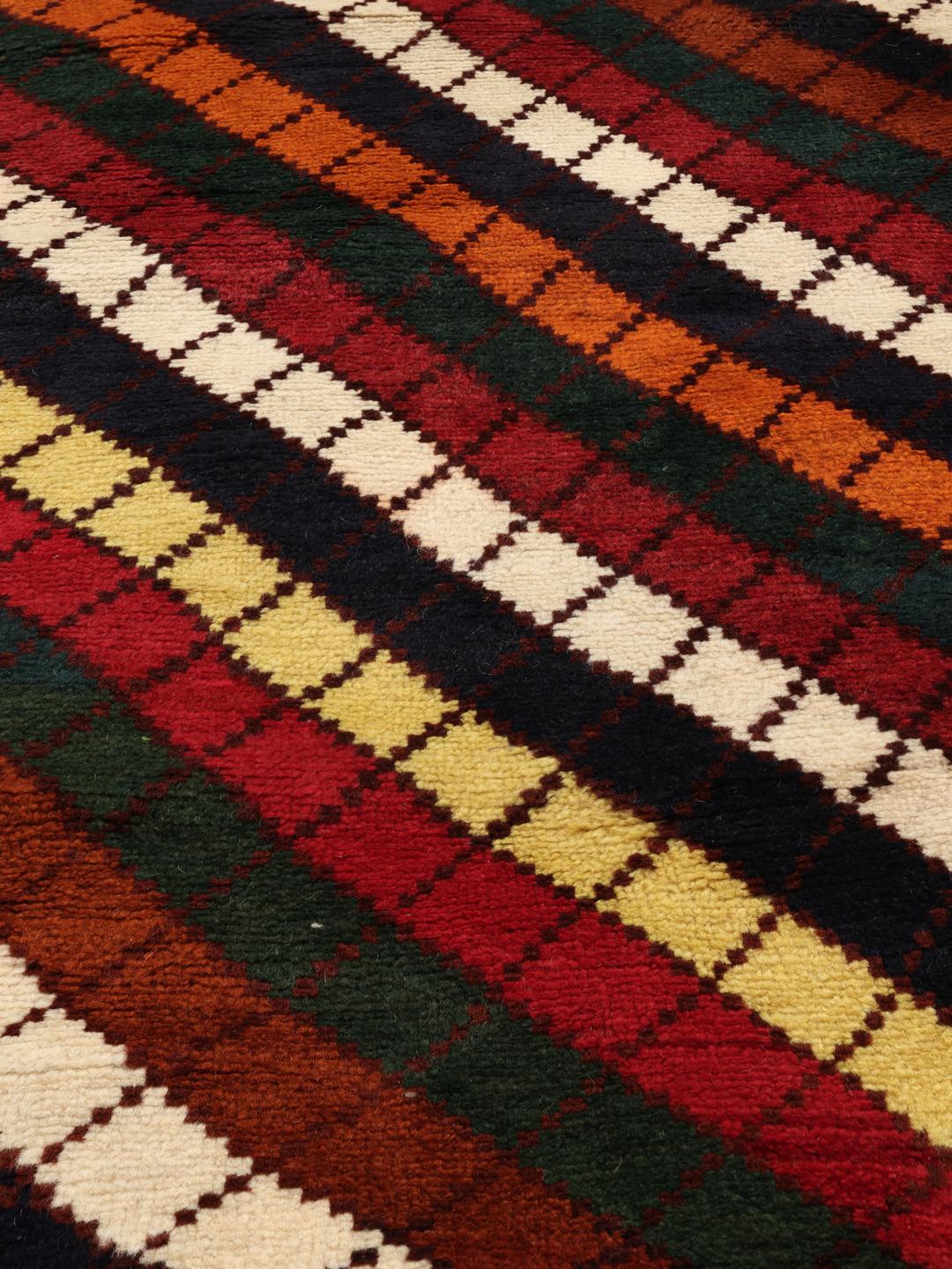 A vibrant, multicoloured Shiraz rug with a bold diagonal pattern and a decorative border.