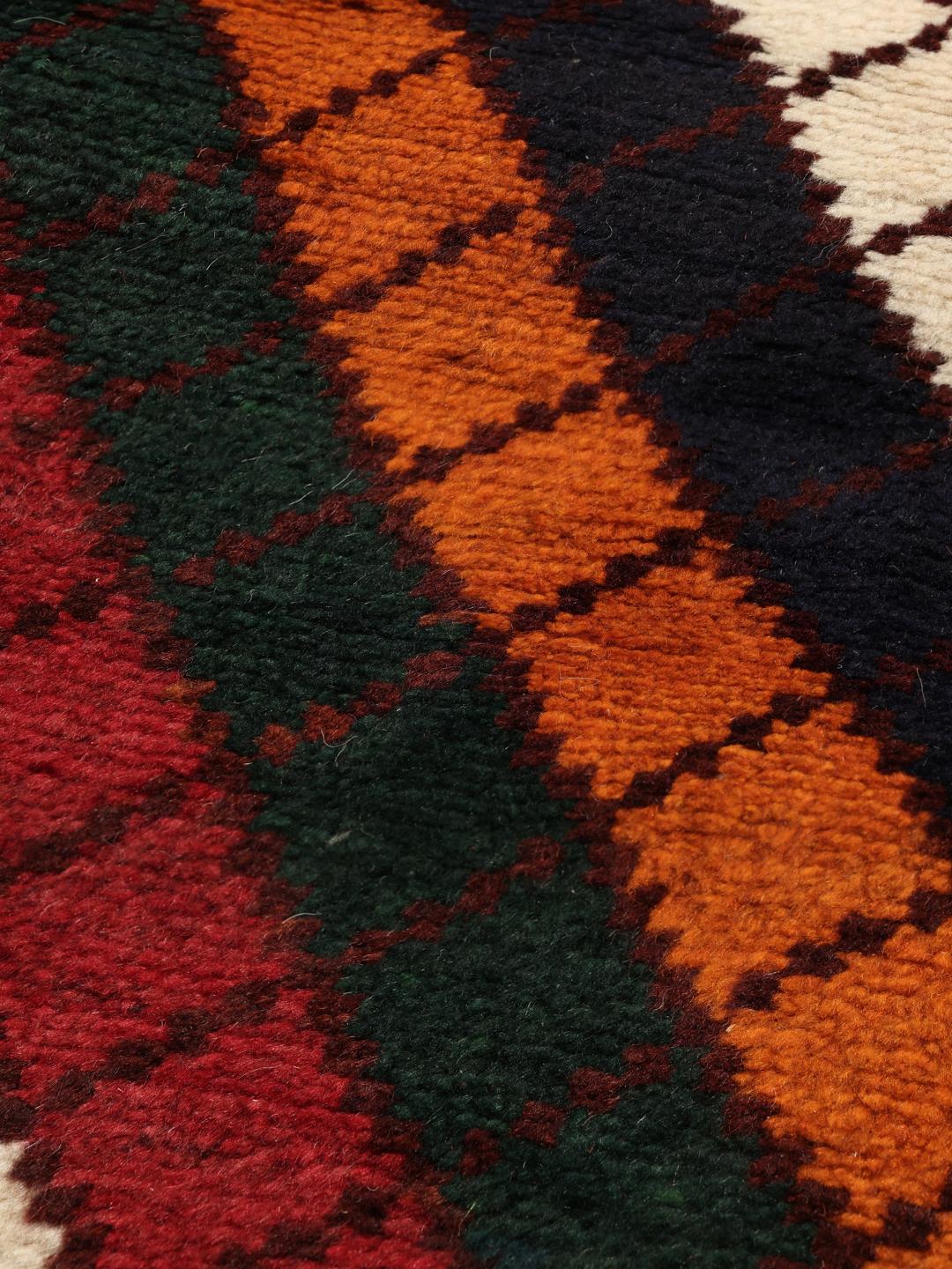 A vibrant, multicoloured Shiraz rug with a bold diagonal pattern and a decorative border.