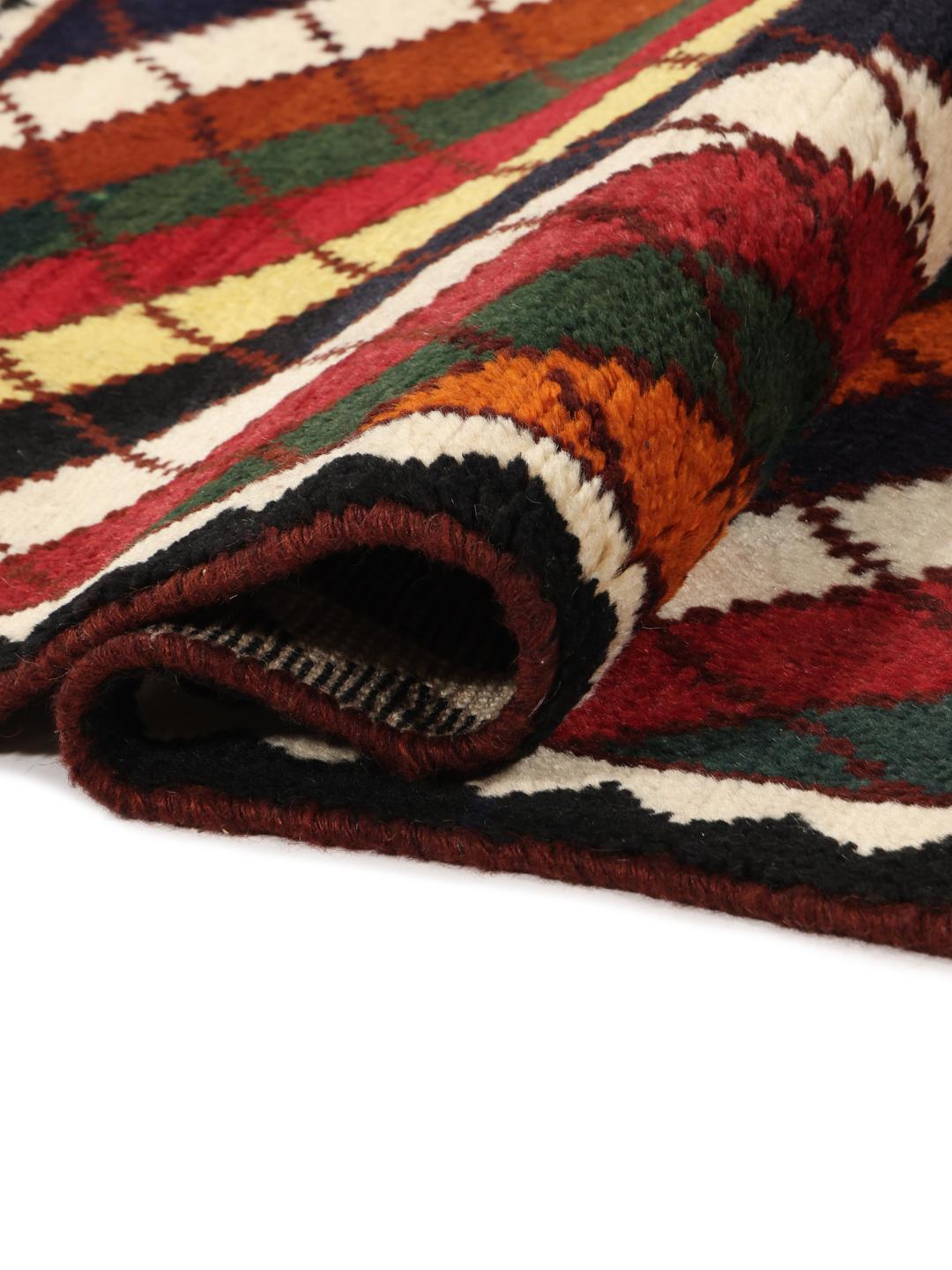 A vibrant, multicoloured Shiraz rug with a bold diagonal pattern and a decorative border.