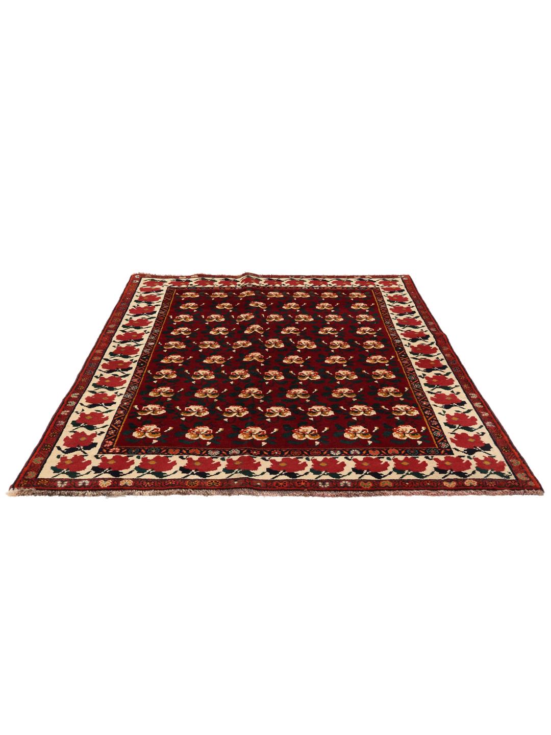 Hand-knotted Ghashghai rug from the Middle East featuring a floral pattern on a red wool background