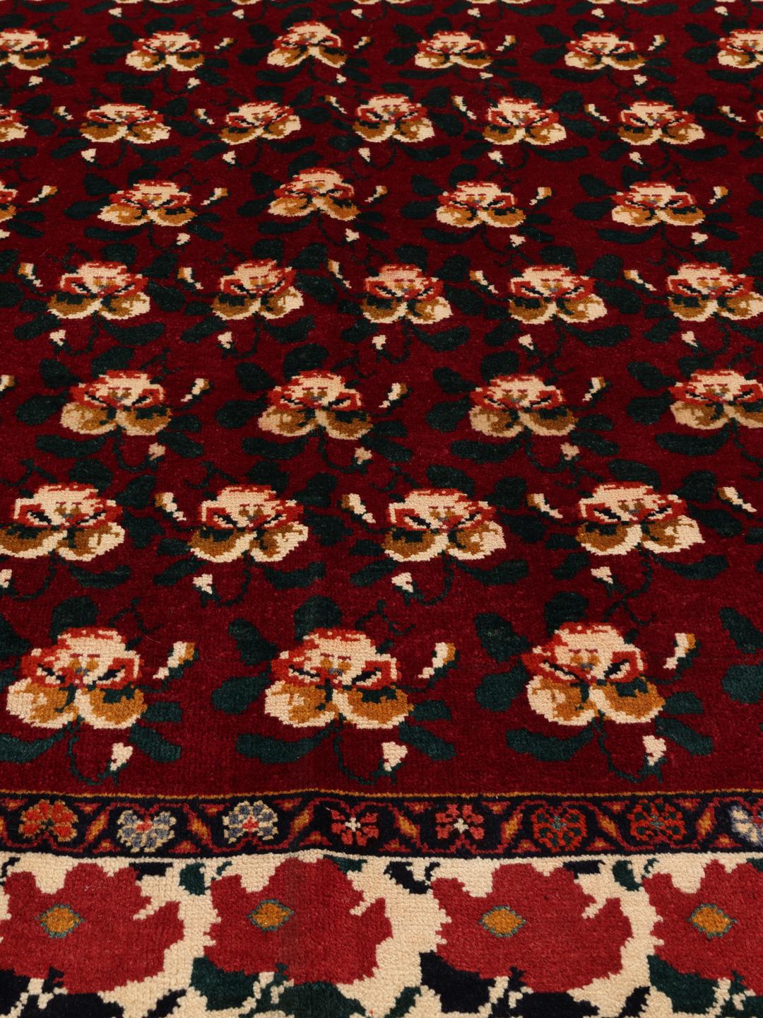 Hand-knotted Ghashghai rug from the Middle East featuring a floral pattern on a red wool background