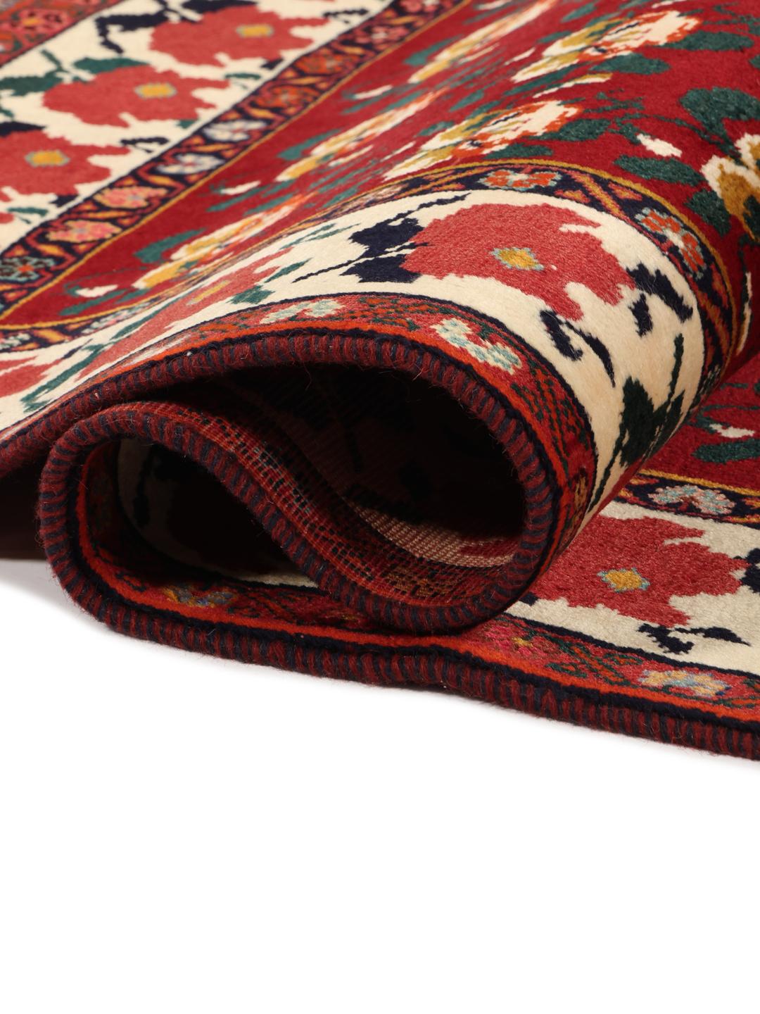 Hand-knotted Ghashghai rug from the Middle East featuring a floral pattern on a red wool background