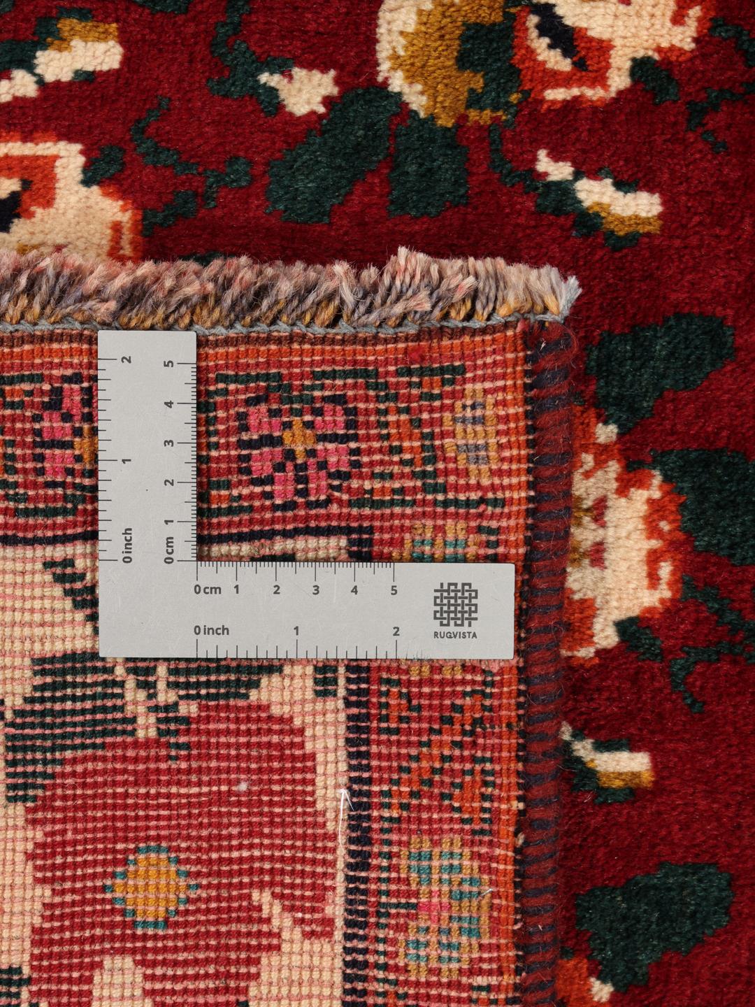 Hand-knotted Ghashghai rug from the Middle East featuring a floral pattern on a red wool background