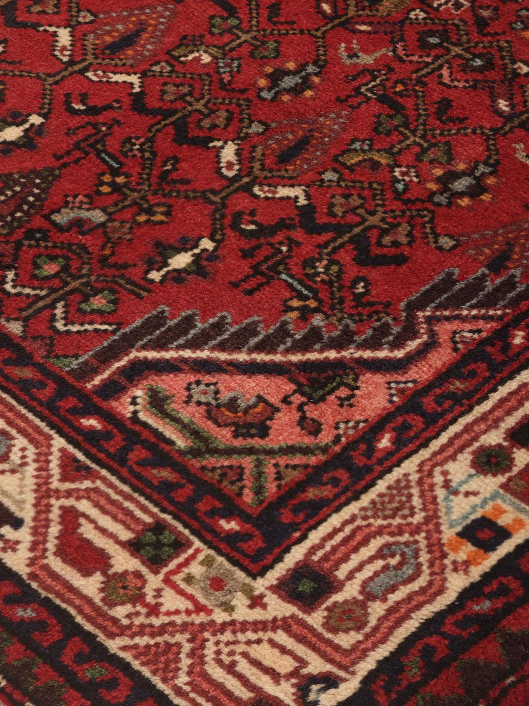 Hand-knotted Asadabad runner in red from the Middle East