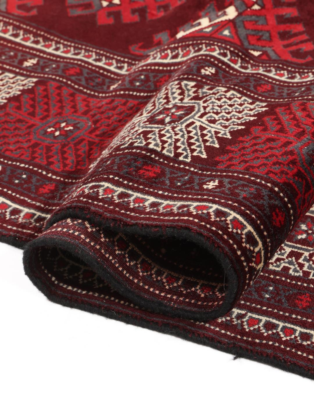 A hand-knotted Turkaman rug from the Middle East in shades of dark-red.