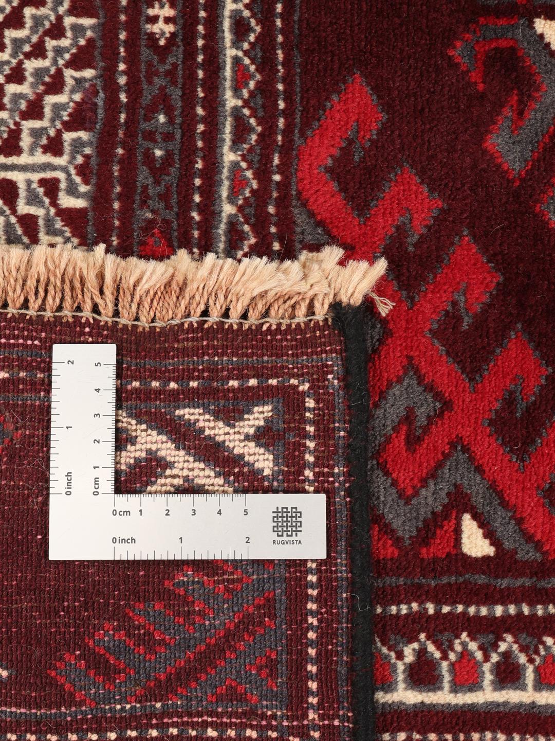 A hand-knotted Turkaman rug from the Middle East in shades of dark-red.