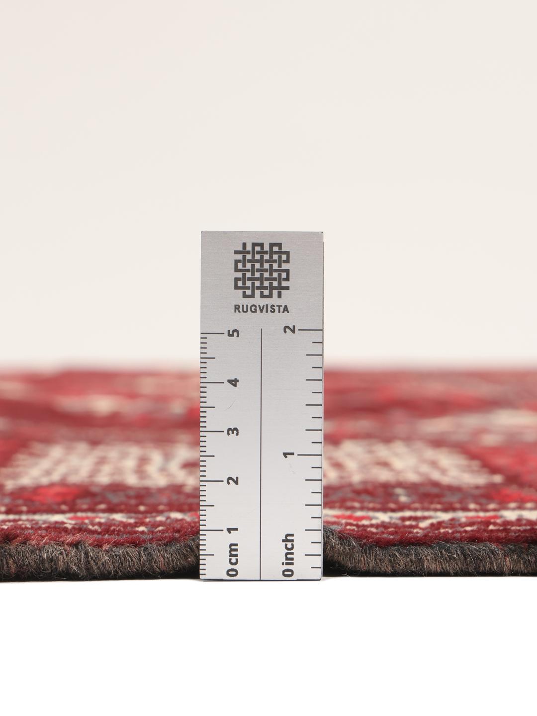 A hand-knotted Turkaman rug from the Middle East in shades of dark-red.