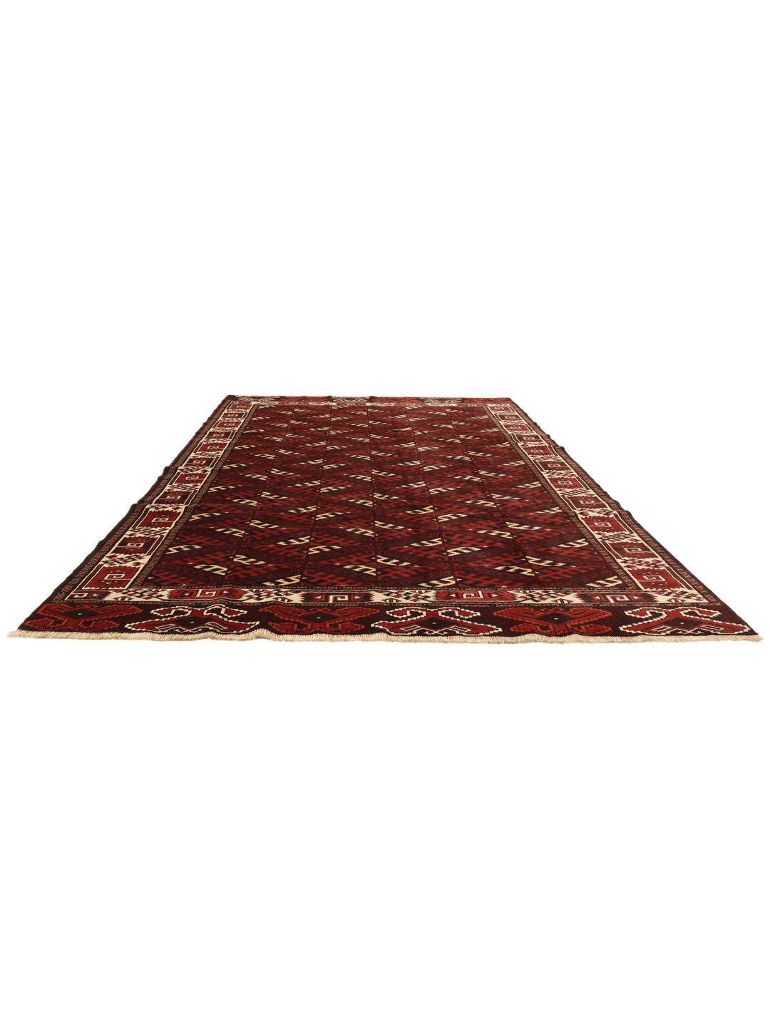 A hand-knotted Turkaman rug from the Middle East featuring a dark-red field and geometric patterns.