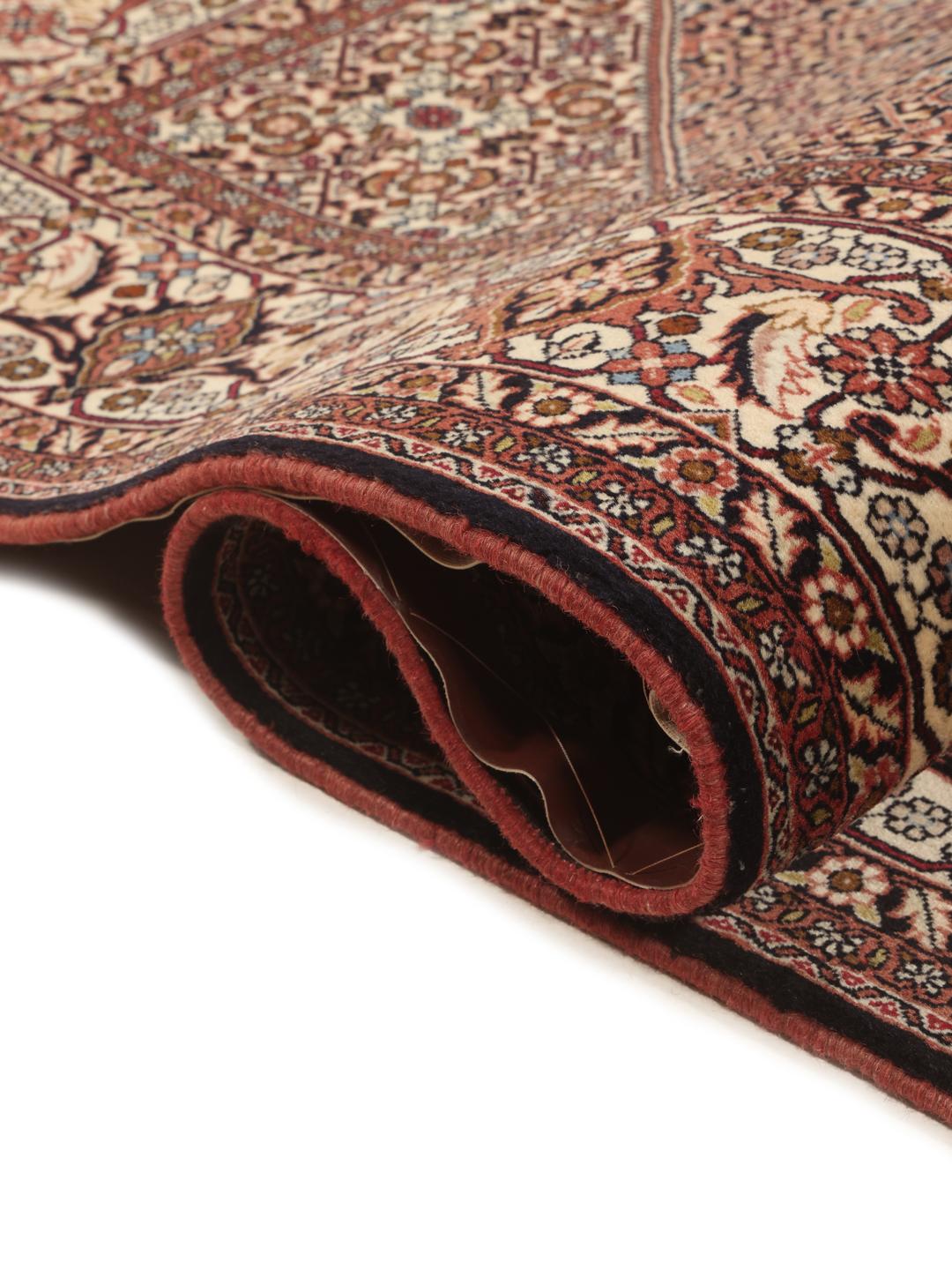 A hand-knotted Bidjar rug from the Middle East with a dark-red field and intricate medallion pattern.