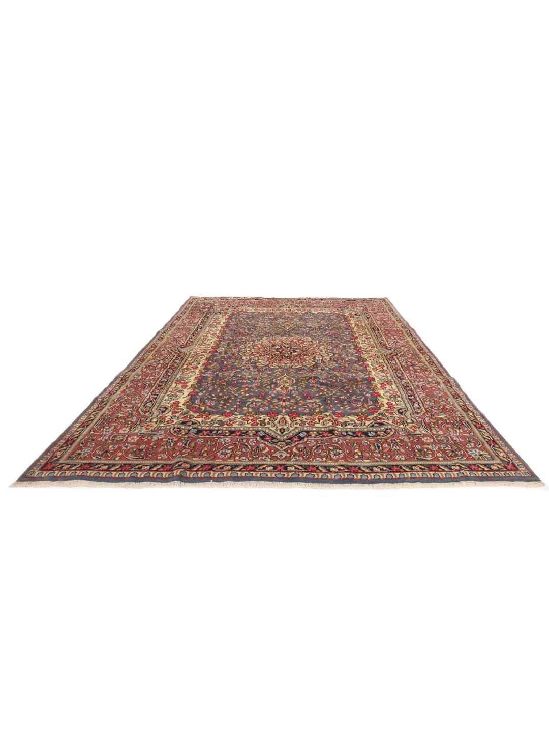 Handgeknoopt Kerman-tapijt met een blauw bloemenmedaillon en rode rand