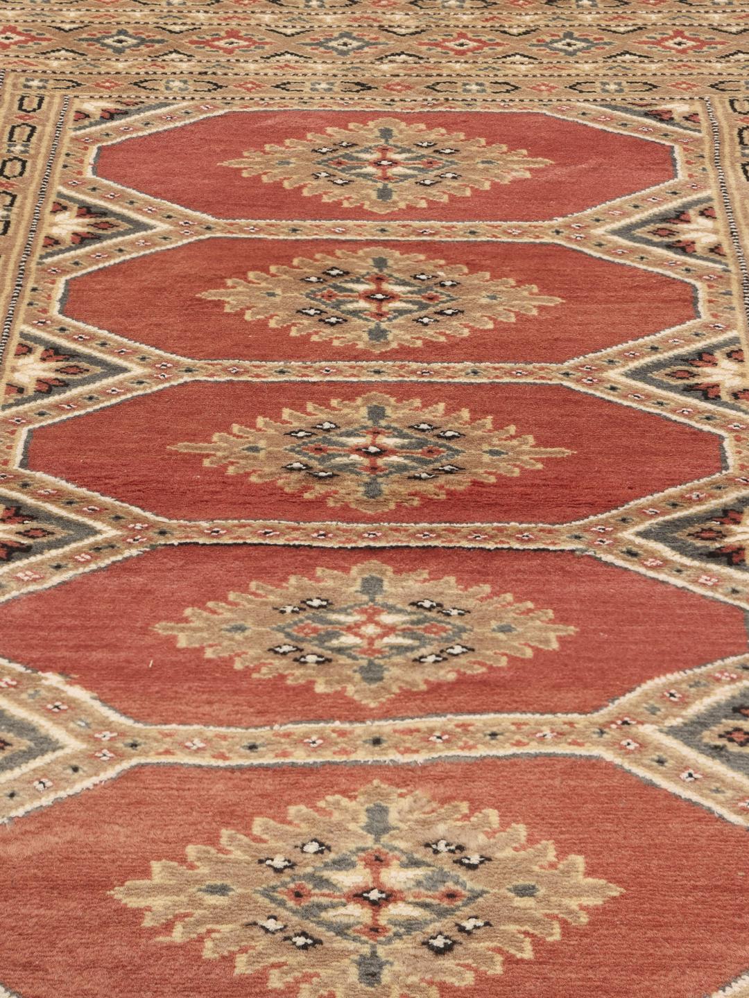 Hand-knotted Pakistan Bokhara 2ply rug in red with detailed tribal motifs