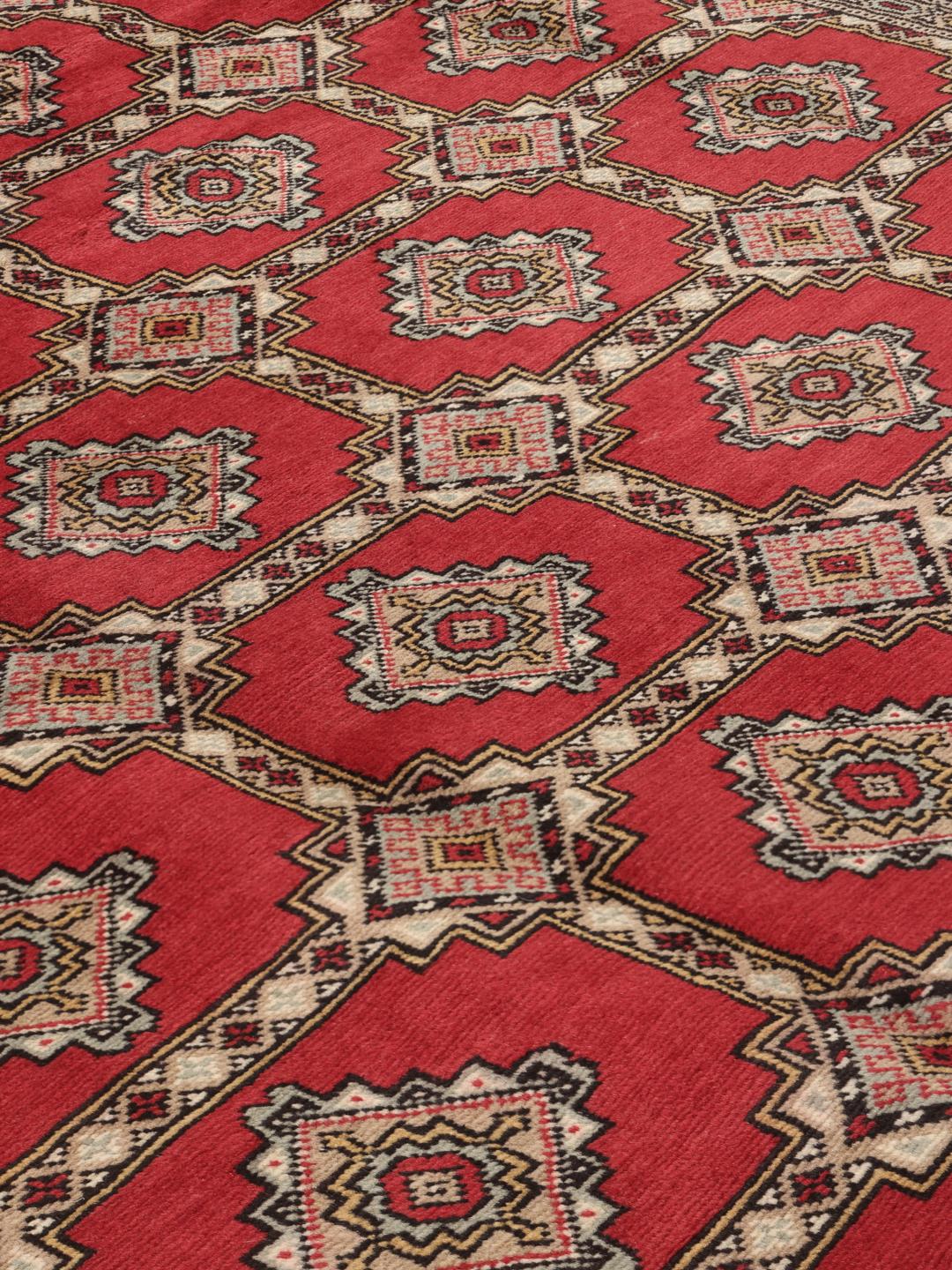Hand-knotted Pakistan Bokhara 2ply rug in red with traditional geometric motifs