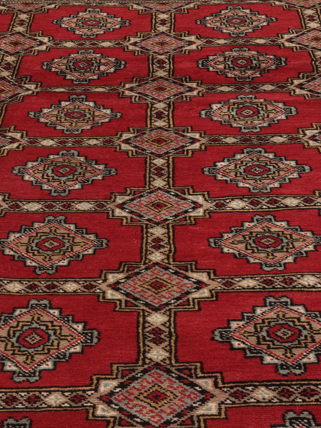 Hand-knotted Pakistan Bokhara 2ply rug in red with traditional geometric motifs